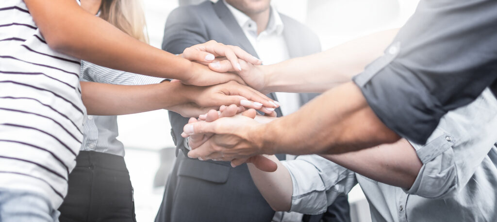 Hands together in a show of teamwork and employees' trust